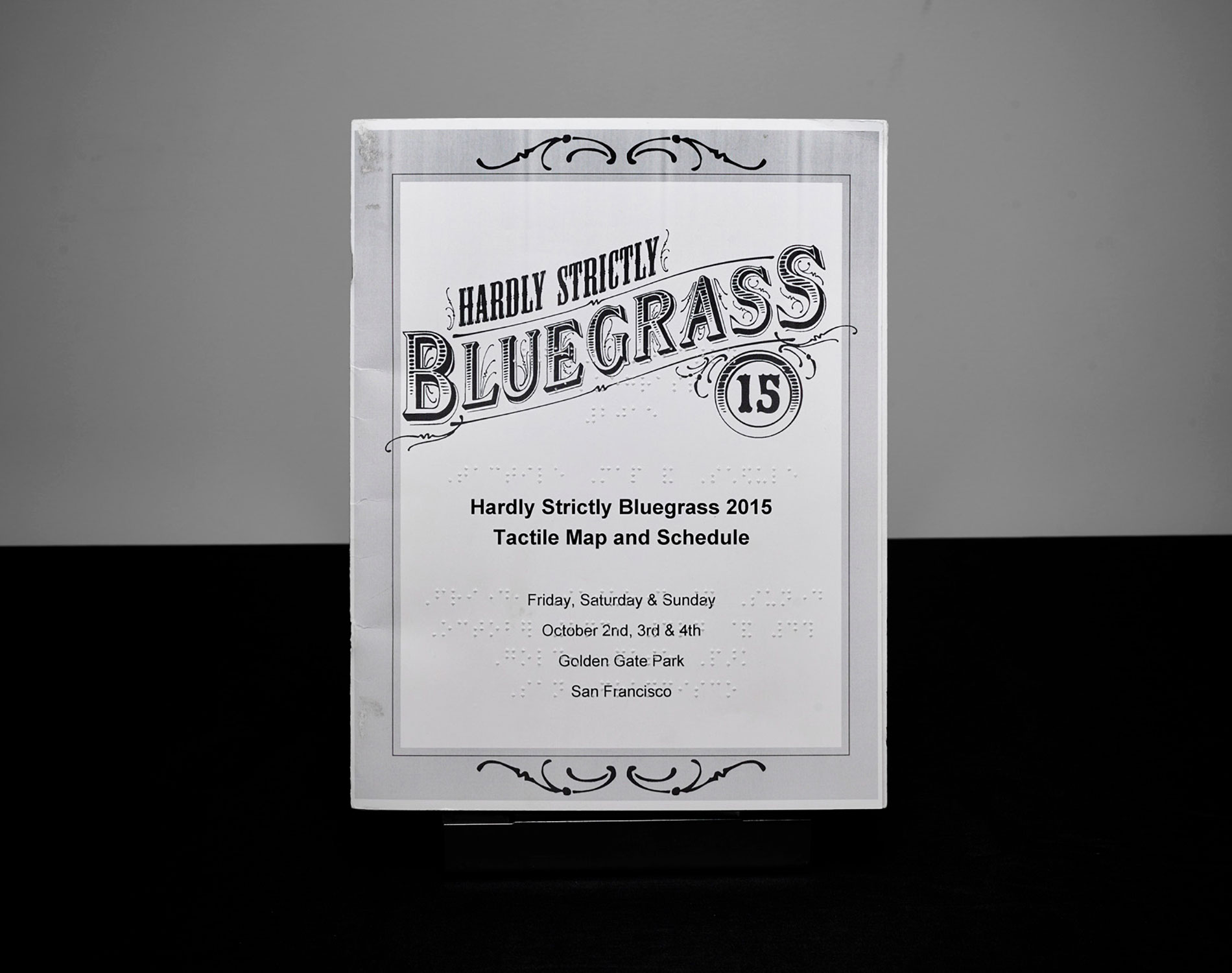 Cover for Hardly Strictly Bluegrass '15 map brochure, with braille and large print.